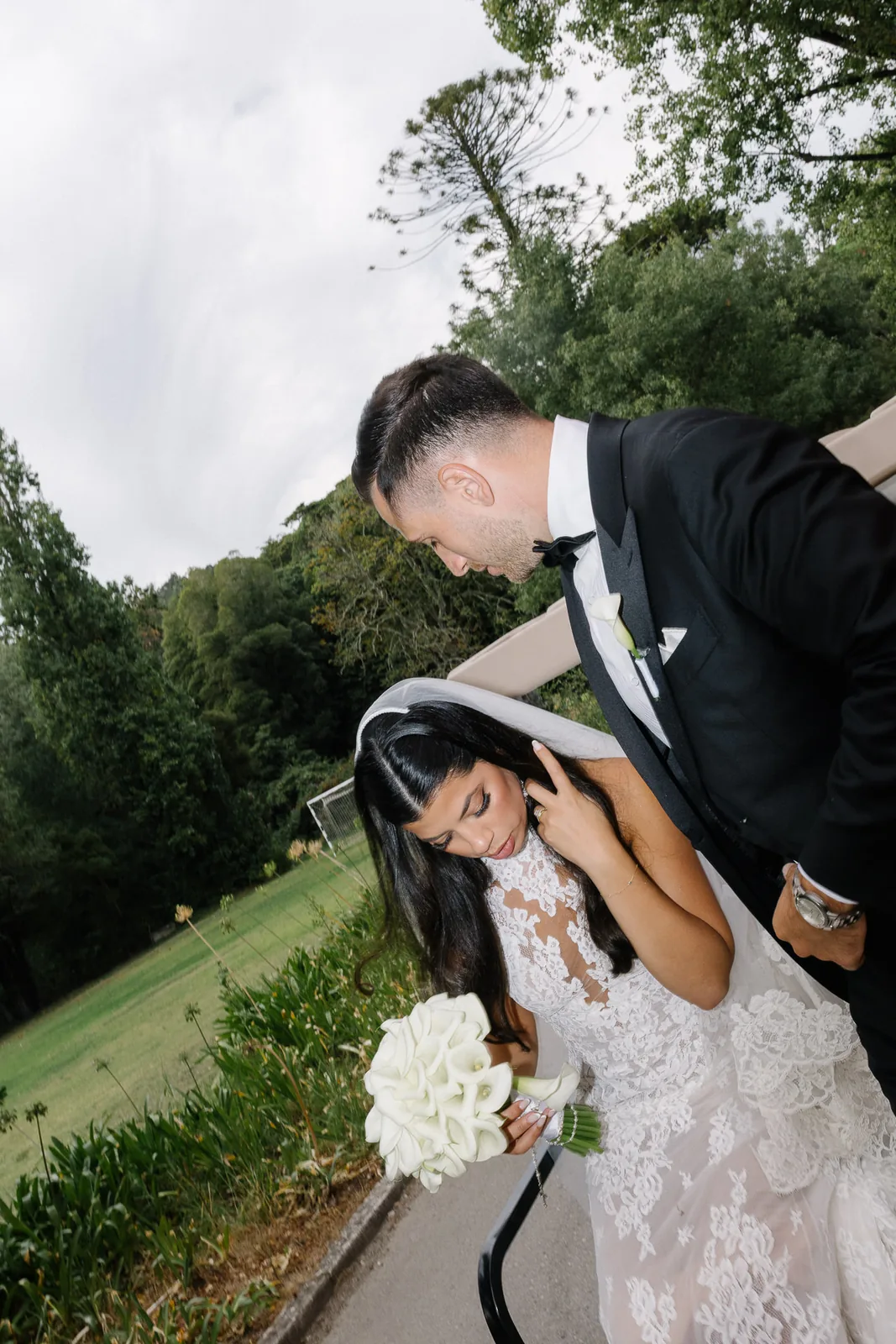 Bride holding calla lily bouquet with lace detail