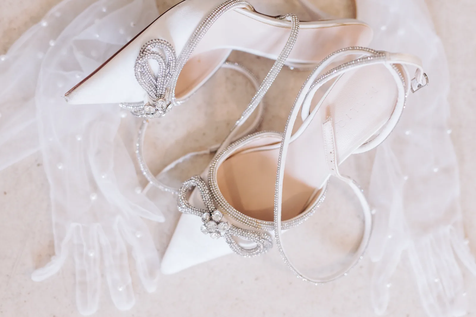 Couple waving to guests at oceanfront celebration