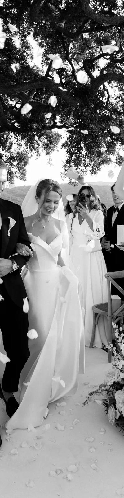 Black and white bride ascending grand palace staircase with floral arch
