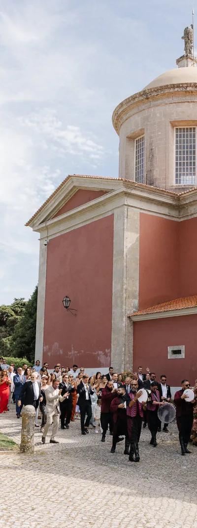 Wedding procession past a red domed palace in Portugal